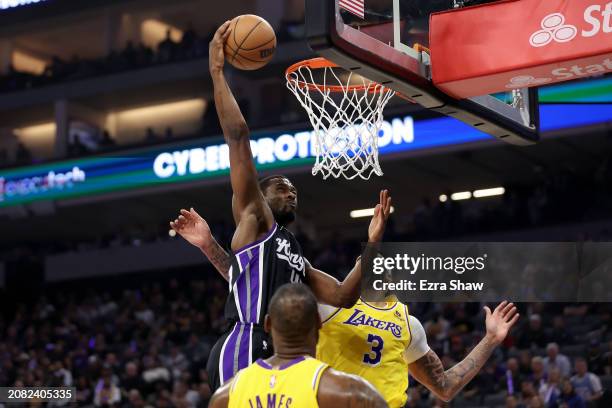 Harrison Barnes of the Sacramento Kings dunks the ball on LeBron James and Anthony Davis of the Los Angeles Lakers in the first half at Golden 1...