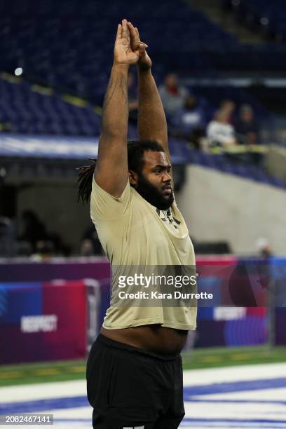 Trente Jones #OL37 of Michigan stretches during the NFL Scouting Combine at Lucas Oil Stadium on March 3, 2024 in Indianapolis, Indiana.