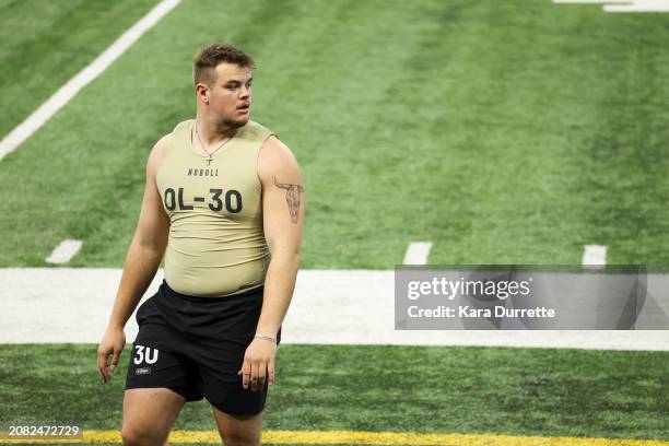 Garret Greenfield #OL30 of South Dakota State walks the field during the NFL Scouting Combine at Lucas Oil Stadium on March 3, 2024 in Indianapolis,...