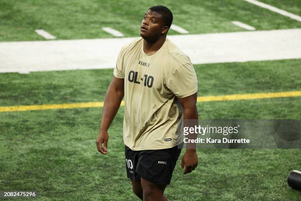 Javion Cohen #OL10 of Miami-Fl walks the field during the NFL Scouting Combine at Lucas Oil Stadium on March 3, 2024 in Indianapolis, Indiana.