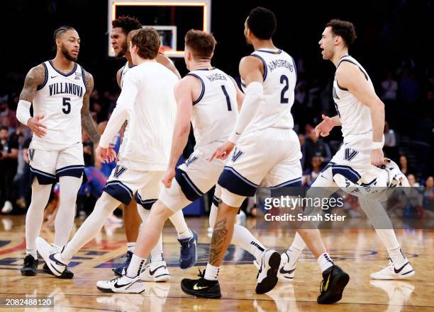 The Villanova Wildcats react after a three-point basket by Justin Moore to win the game in the second half against the DePaul Blue Demons during the...
