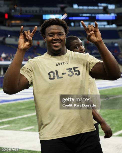 Christian Jones #OL35 of Texas gestures during the NFL Scouting Combine at Lucas Oil Stadium on March 3, 2024 in Indianapolis, Indiana.