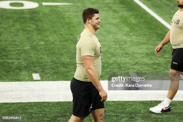 Joe Alt #OL02 of Notre Dame walks the sideline during the NFL Scouting Combine at Lucas Oil Stadium on March 3, 2024 in Indianapolis, Indiana.