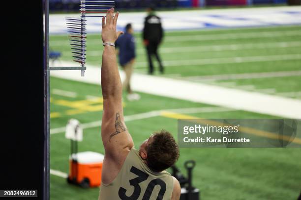 Garret Greenfield #OL30 of South Dakota State participates in the vertical jump during the NFL Scouting Combine at Lucas Oil Stadium on March 3, 2024...