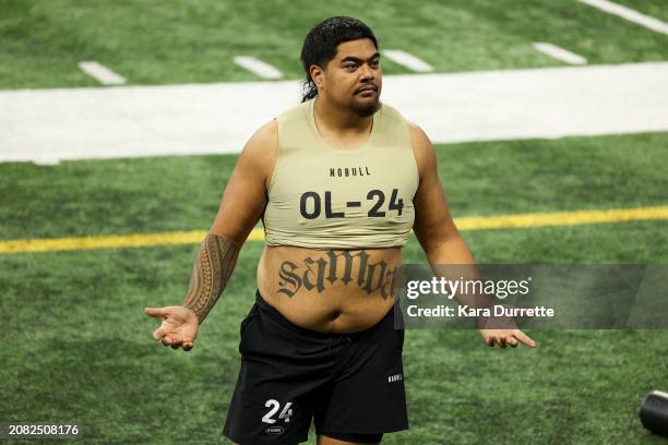 Taliese Fuaga #OL24 of Oregon State gestures during the NFL Scouting Combine at Lucas Oil Stadium on March 3, 2024 in Indianapolis, Indiana.