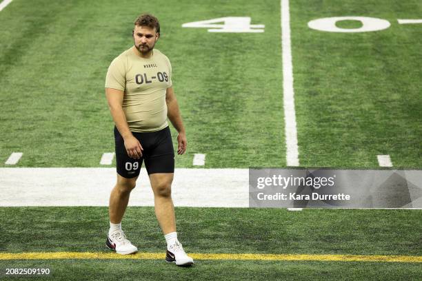 Tanor Bortolini #OL09 of Wisconsin walks the field during the NFL Scouting Combine at Lucas Oil Stadium on March 3, 2024 in Indianapolis, Indiana.