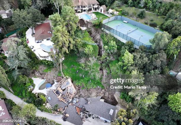 An aerial view shows a landslide which destroyed one home and damaged two others in the Sherman Oaks neighborhood on March 13, 2024 in Los Angeles,...