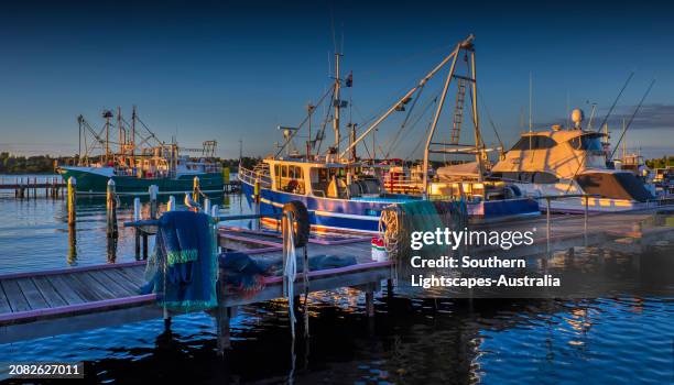 dawn light on a late summer's morning  at the lakes entrance harbour, victoria, australia. - australia jetty stock pictures, royalty-free photos & images