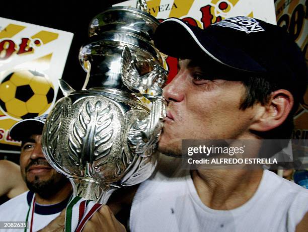Guillermo Franco of Monterrey kisses the throphy after they won against Morelia in the Mexican Soccer league Championship, 14 June 2003 in Morelia,...