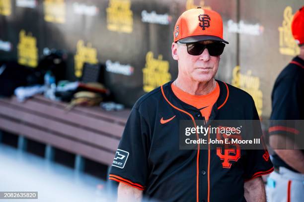 Bob Melvin of the San Francisco Giants walks through the dugout during the spring training game against the Seattle Mariners at Peoria Sports Complex...