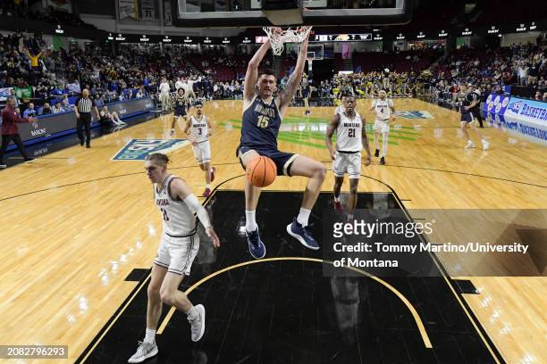 John Olmsted of the Montana State Bobcats slam dunks over Aanen Moody of the Montana Grizzlies in the first half during the Big Sky Conference...