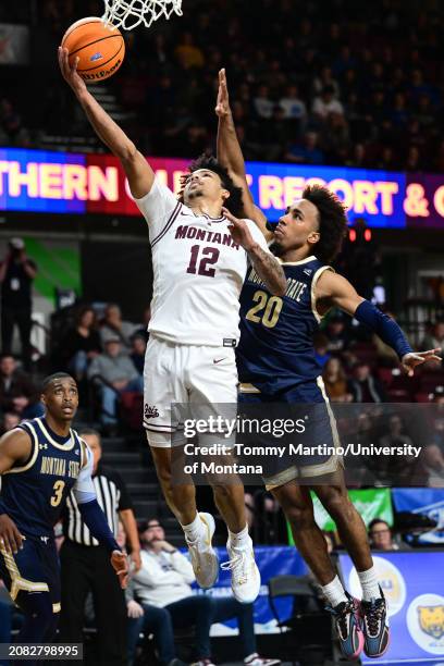 Brandon Whitney of the Montana Grizzlies shoots the ball over Robert Ford III of the Montana State Bobcats in the first half during the Big Sky...