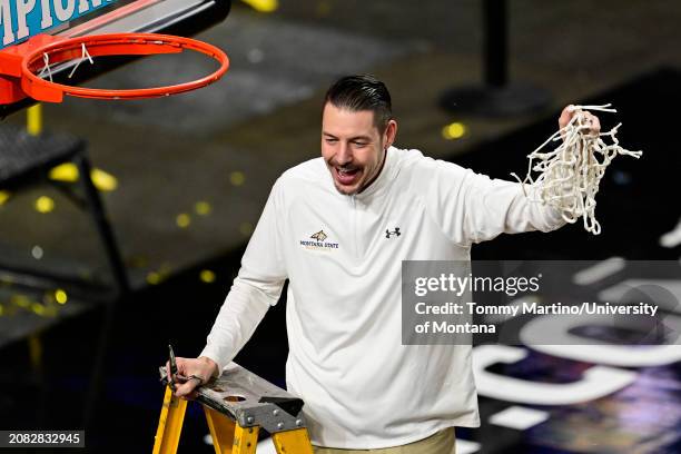 Head coach Matt Logie of the Montana State Bobcats cuts down the net after beating the Montana Grizzlies 85-70 during the Big Sky Conference...