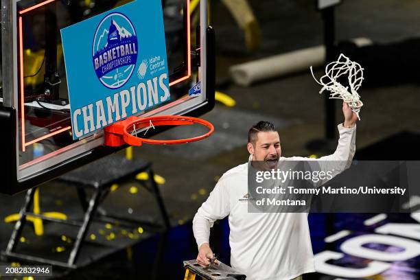 Head coach Matt Logie of the Montana State Bobcats cuts down the net after beating the Montana Grizzlies 85-70 during the Big Sky Conference...