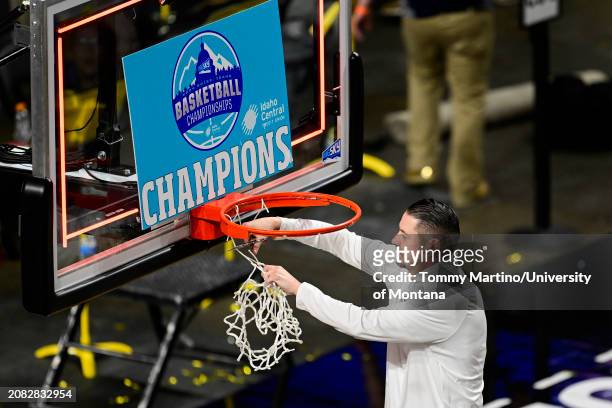 Head coach Matt Logie of the Montana State Bobcats cuts down the net after beating the Montana Grizzlies 85-70 during the Big Sky Conference...