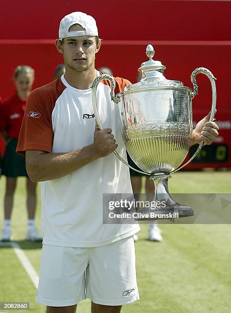 Andy Roddick of the USA celebrates winning with trophy after the final of the Stella Artois Championship against Sebastien Grosjean of France on June...