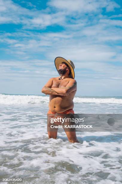 happy man on a beach in costa rica who is overweight. - men abs beach photos et images de collection