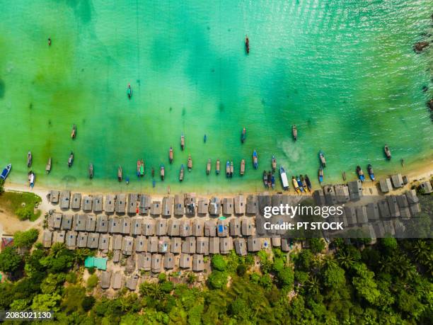 aerial view drone wooden boat and house on sea beach, morgan village, mu koh surin national park, andaman sea, phangnga, travel in thailand - surin beach stock pictures, royalty-free photos & images