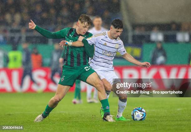 Luca Netz of Borussia Mönchengladbach and Amine Naifi of 1. FC Saarbrücken compete for the ball during the DFB cup quarterfinal match between 1. FC...