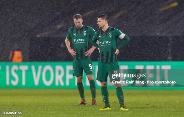 Marvin Friedrich of Borussia Mönchengladbach and teammate Julian Weigl look dejected after the DFB cup quarterfinal match between 1. FC Saarbrücken...