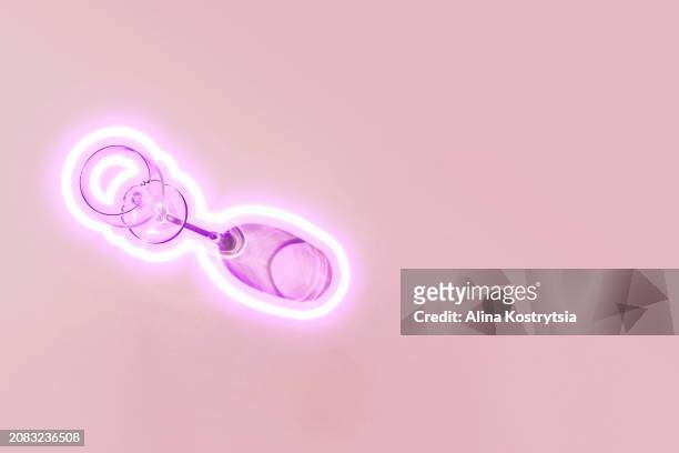 glass and shadow with glowing neon surround on pink background - empty glasses after party stock pictures, royalty-free photos & images