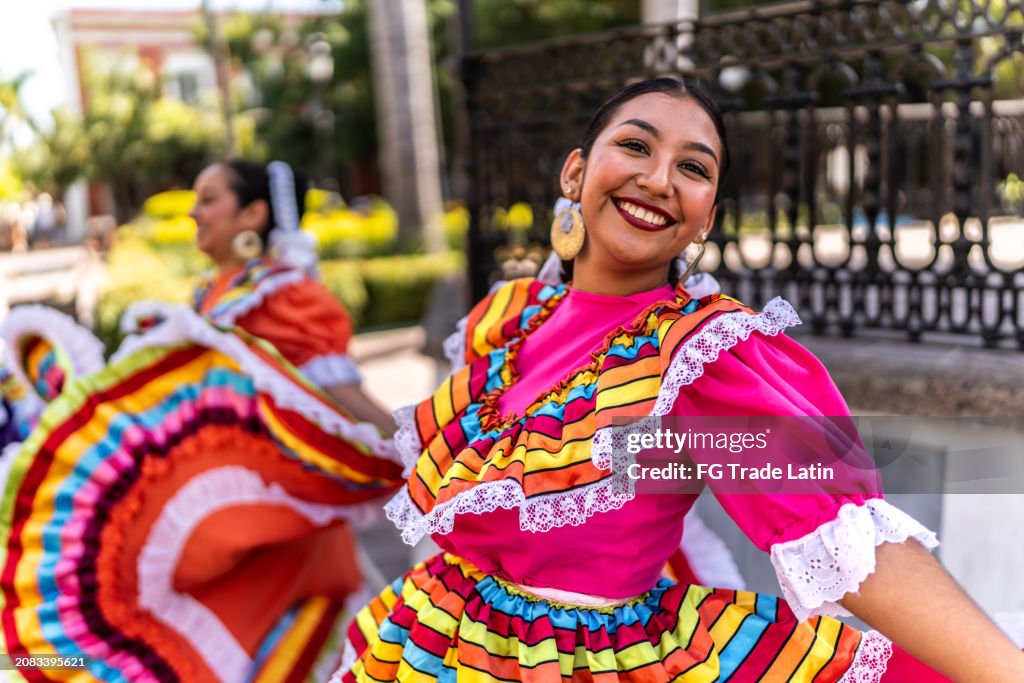 Portrait of a young woman dancing in traditional festival at public park