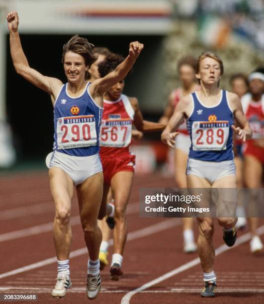 East Germany athlete Sigrun Wodars celebrates as she crosses the finish line in first place to win the gold medal in the final of the Women's 800...