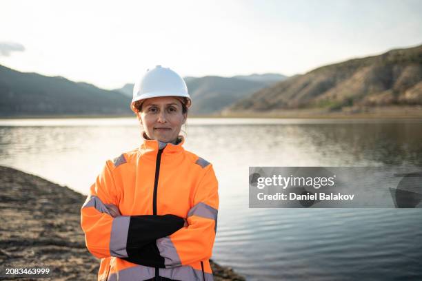 portrait of smiling female hydroelectric engineer. - water reservoir stock pictures, royalty-free photos & images