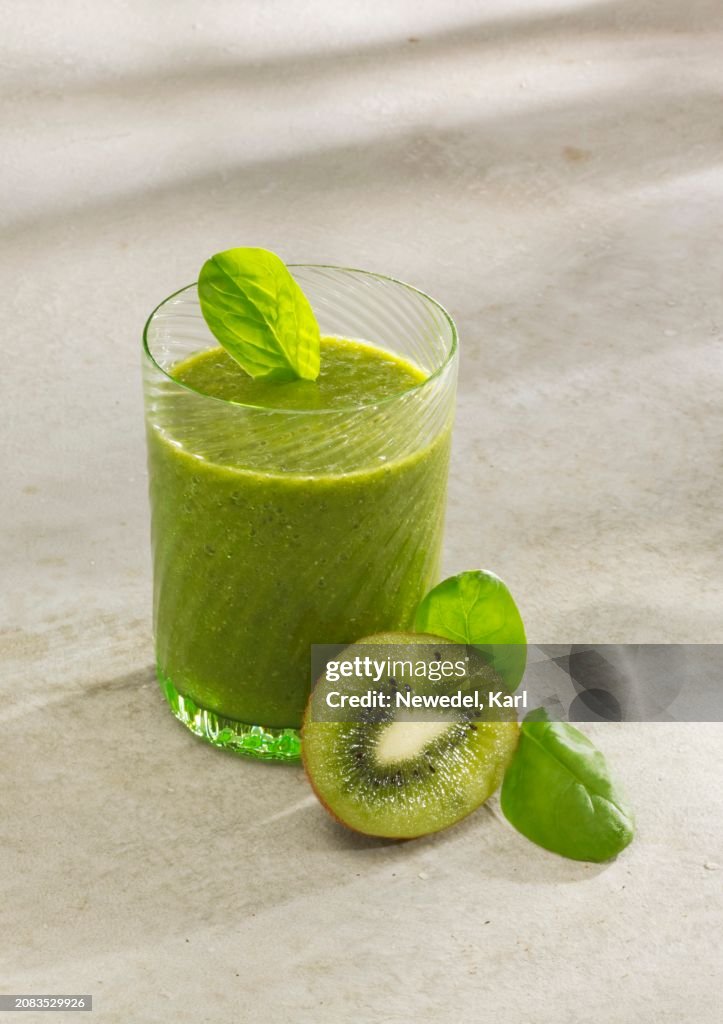 Spinach and kiwi smoothie with almond milk, chia seeds and wheat grass powder