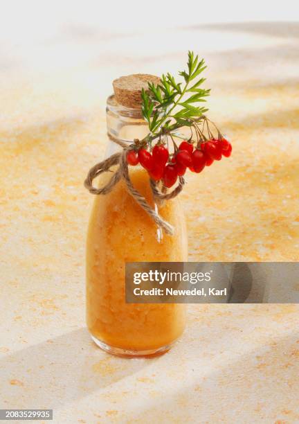A Pineapple And Carrot Smoothie With Orange Juice And Goji Berries High-Res Stock Photo