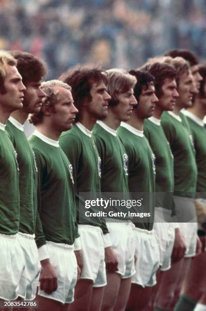 The West Germany team in their green away strip including Paul Breitner Bert Vogts and Gerd Muller line up for the national anthem before a match...