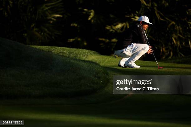 Xander Schauffele of the United States lines up a putt on the 10th green during the first round of THE PLAYERS Championship on the Stadium Course at...