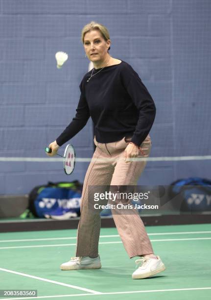 Sophie, Duchess of Edinburgh hits the shuttlecock as she takes part in a badminton match during a visit to the All England Open Badminton...