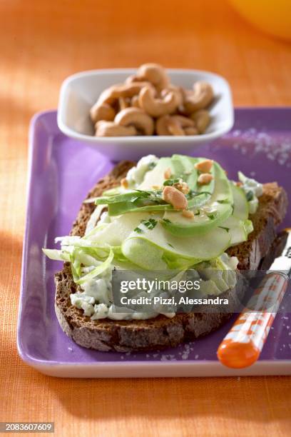 dark bread topped with roquefort, apples, avocado and cashew nuts - cashew pieces stock pictures, royalty-free photos & images