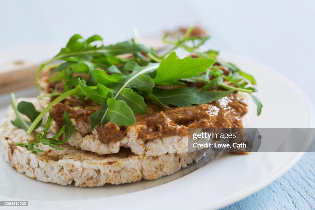 Rice waffles topped with almond butter and rocket (close)