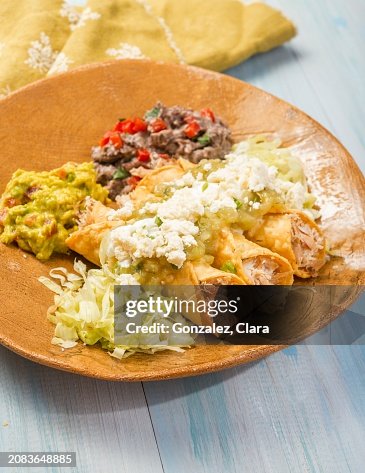Taquitos with chicken, guacamole, queso fresco and bean purée (Mexico) Taquitos with chicken, guacamole, queso fresco and bean purée (Mexico)