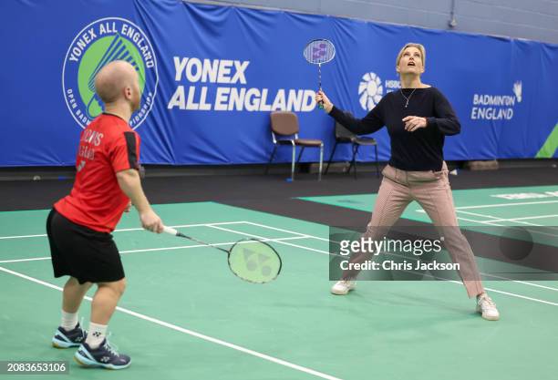 Sophie, Duchess of Edinburgh attempts to hits the shuttlecock as she takes part in a badminton match with Para badminton player Krysten Coombs during...