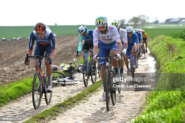 Kelland O'brien of Australia and Team Jayco AlUla and Anthony Turgis of France and Team TotalEnergies compete passing through a cobblestones sector...