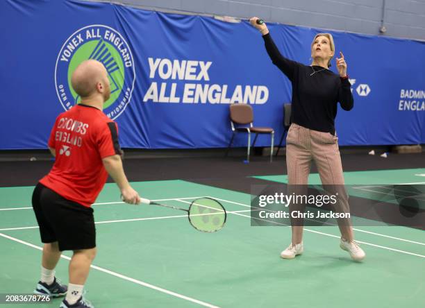 Sophie, Duchess of Edinburgh attempts to hits the shuttlecock as she takes part in a badminton match with Para badminton player Krysten Coombs during...