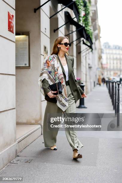 Alexandra Lapp is seen wearing a Windsor blazer in olive, a Colorful Standard tank top in white, a Windsor belt with purse in olive, Rossi pants in...