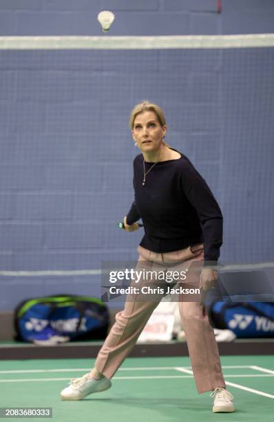 Sophie, Duchess of Edinburgh hits the shuttlecock as she takes part in a badminton match during a visit to the All England Open Badminton...