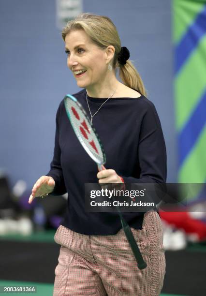 Sophie, Duchess of Edinburgh smiles as she takes part in a badminton match at the All England Open Badminton Championships with Prince Edward, Duke...