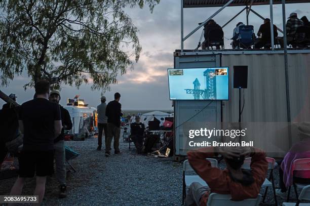 People wait together for the launch of the SpaceX Starship Flight 3 Rocket near the Starbase facility on March 14, 2024 in Brownsville, Texas. The...