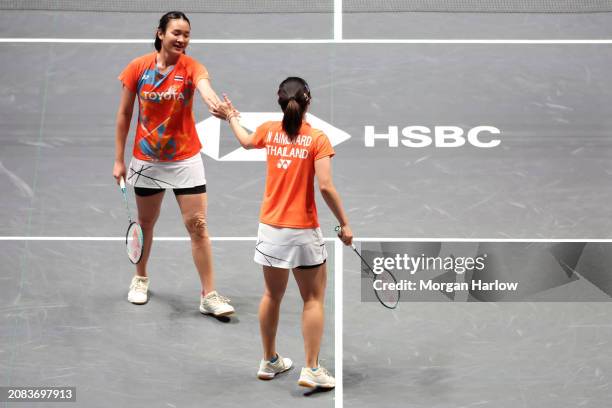 Benyapa Aimsaard and Nuntakarn Aimsaard of Thailand react against Liu Shengshu and Tan Ning of China in the Women's Doubles on Day Three of the Yonex...