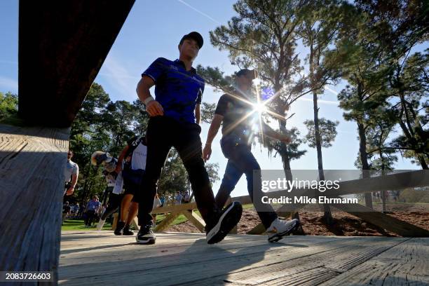 Viktor Hovland of Norway and Rory McIlroy of Northern Ireland walk to the 16th hole during the first round of THE PLAYERS Championship on the Stadium...