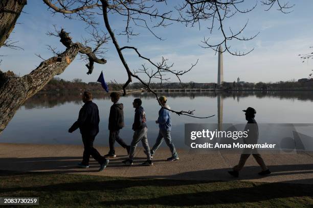 Student tour group walks past the Cherry Blossom trees on the Tidal Basin on March 14, 2024 in Washington, DC. The National Park Service announced...