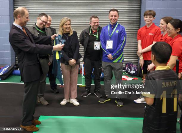 Prince Edward, Duke of Edinburgh shares a joke with local schoolchildren, who are funded by the YONEX All England Legacy Project, as he holds a...