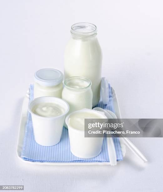 yoghurt in assorted glasses and cups - yogurt container stock pictures, royalty-free photos & images