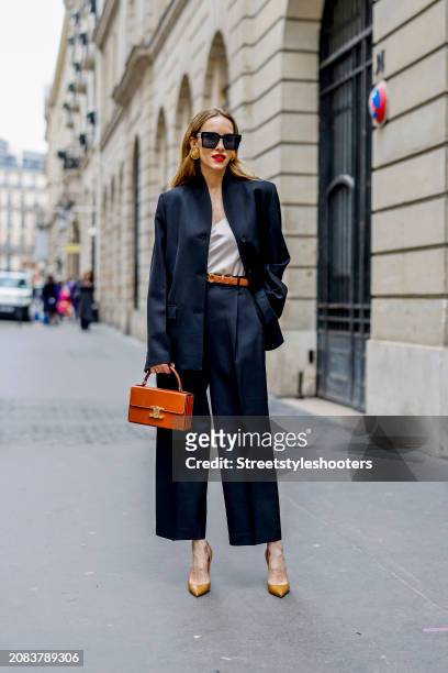 Alexandra Lapp is seen wearing a Toteme Overlay Blazer in black,Toteme Cotton Blend trousers in black, a Dorothee Schumacher top in creme, a Celine...