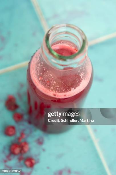 lingonberry juice in a glass bottle - cranberry juice stock pictures, royalty-free photos & images